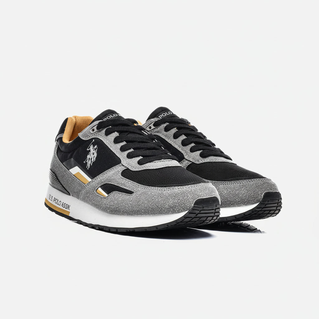 Gray and black sneakers with a visible brand logo on a white background