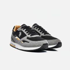 Gray and black sneakers with a visible brand logo on a white background